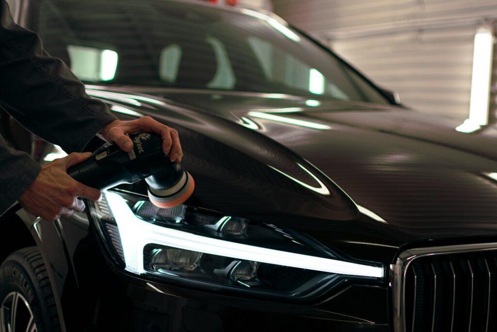 Professionnel r&eacute;alisant un polissage automobile