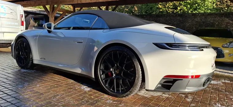 Porsche 911 blanche, vue arri&egrave;re trois quarts sur pav&eacute;s