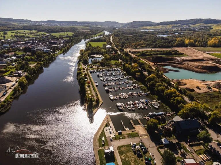 Vue aérienne du Dream Car Festival au Luxembourg : alignements de voitures et chapiteaux